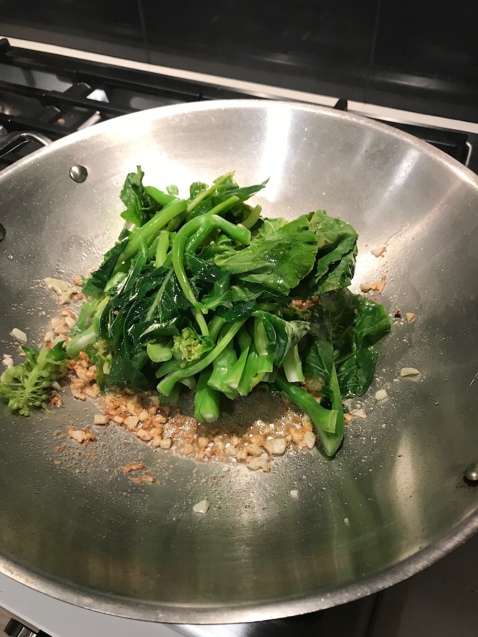 Fresh gai lan in a frying pan